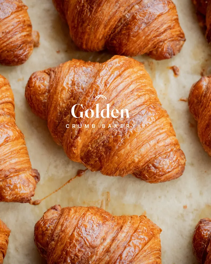 Golden Crumb Bakery logo watermarked on a photo of croissants