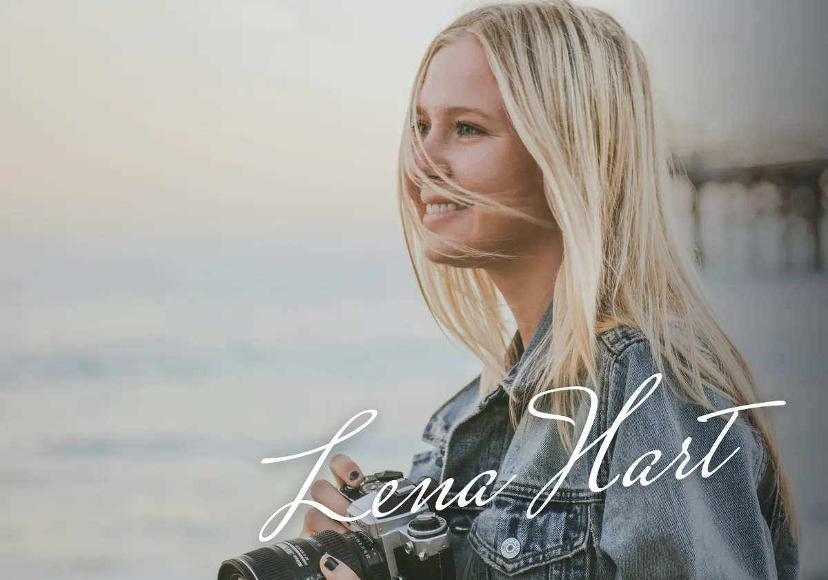 A photographer on the beach with a hand-drawn Lena Hart signature watermark